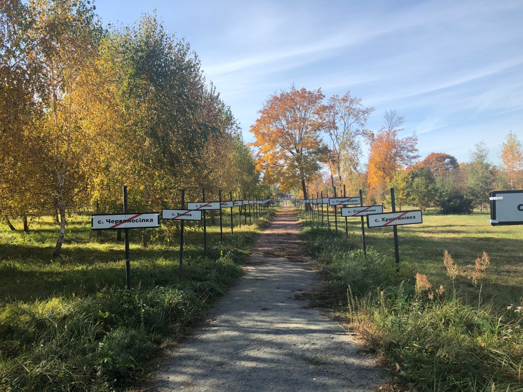 A picture of the Memorial "Wormwood Star". Depicts a road with crossed out signs of cities.