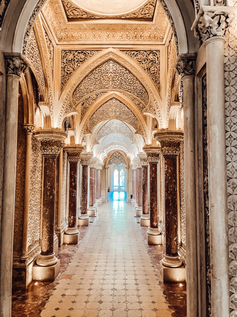 The picture shows the inside of Monserrate Palace - golden arches supported by columns
