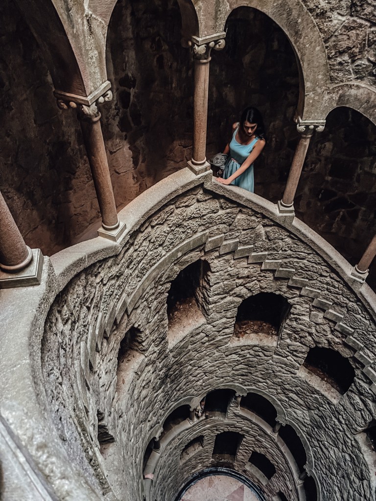 A picture of the author, climbing down the stairs inside the Mason's Initiation Well in Sintra