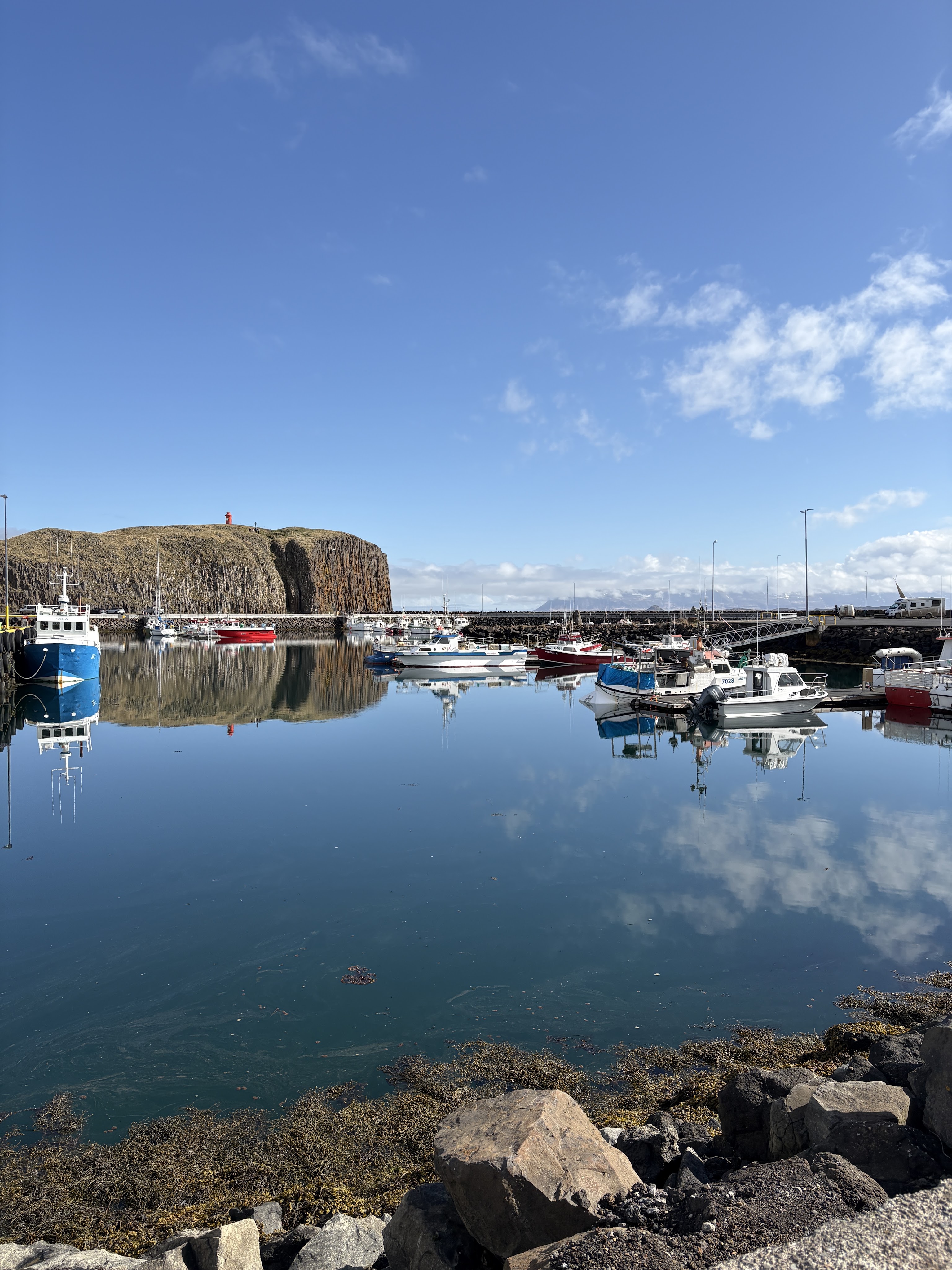 Stykkisholmur's port, with view to the cliffs and lighthouse on top